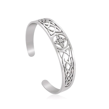 Silver bracelet with intricate Celtic knot design on a white background